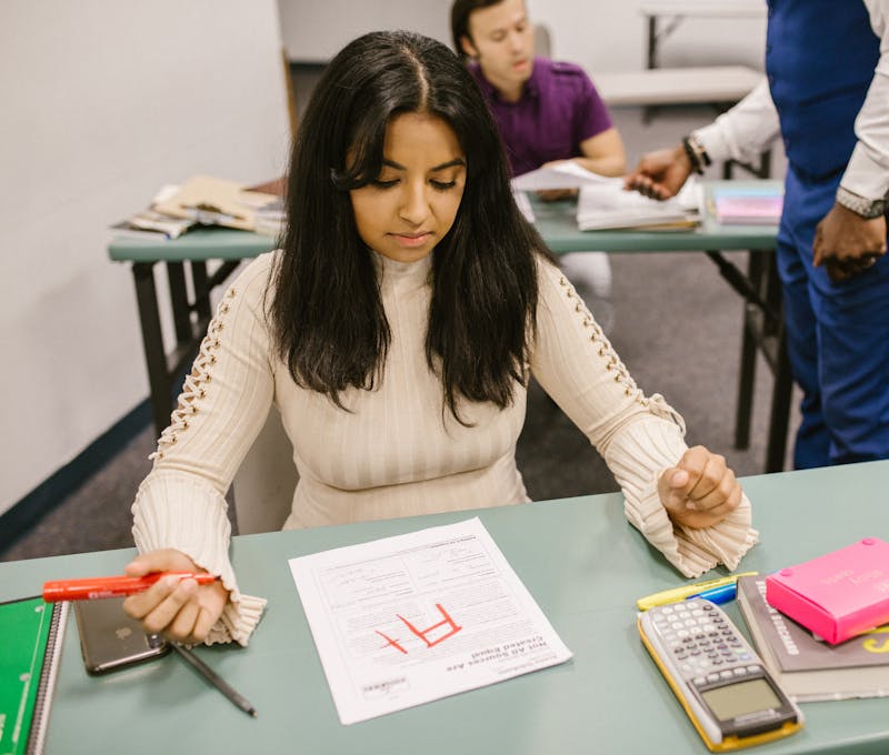 A college student is given an F grade in a classroom setting during an exam.