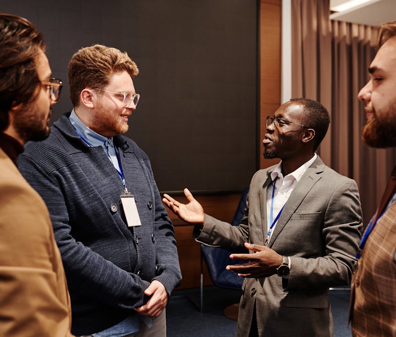 Group of diverse business professionals engaged in a lively discussion indoors.